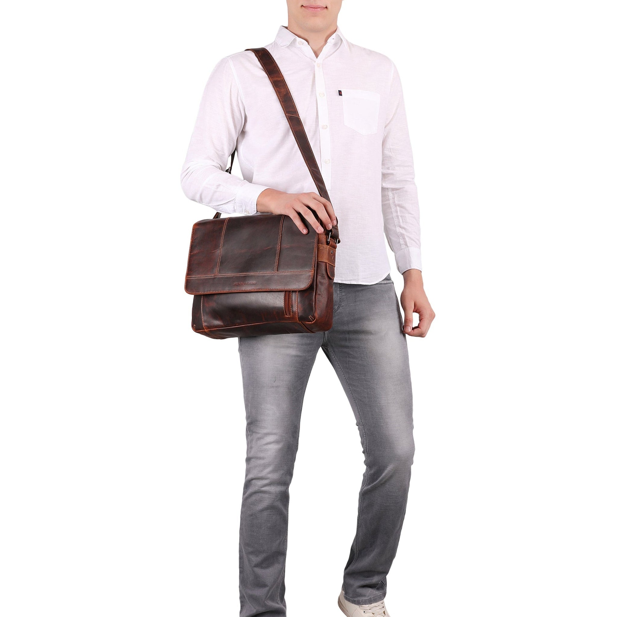 Person holding a brown Minori leather bag against a white background