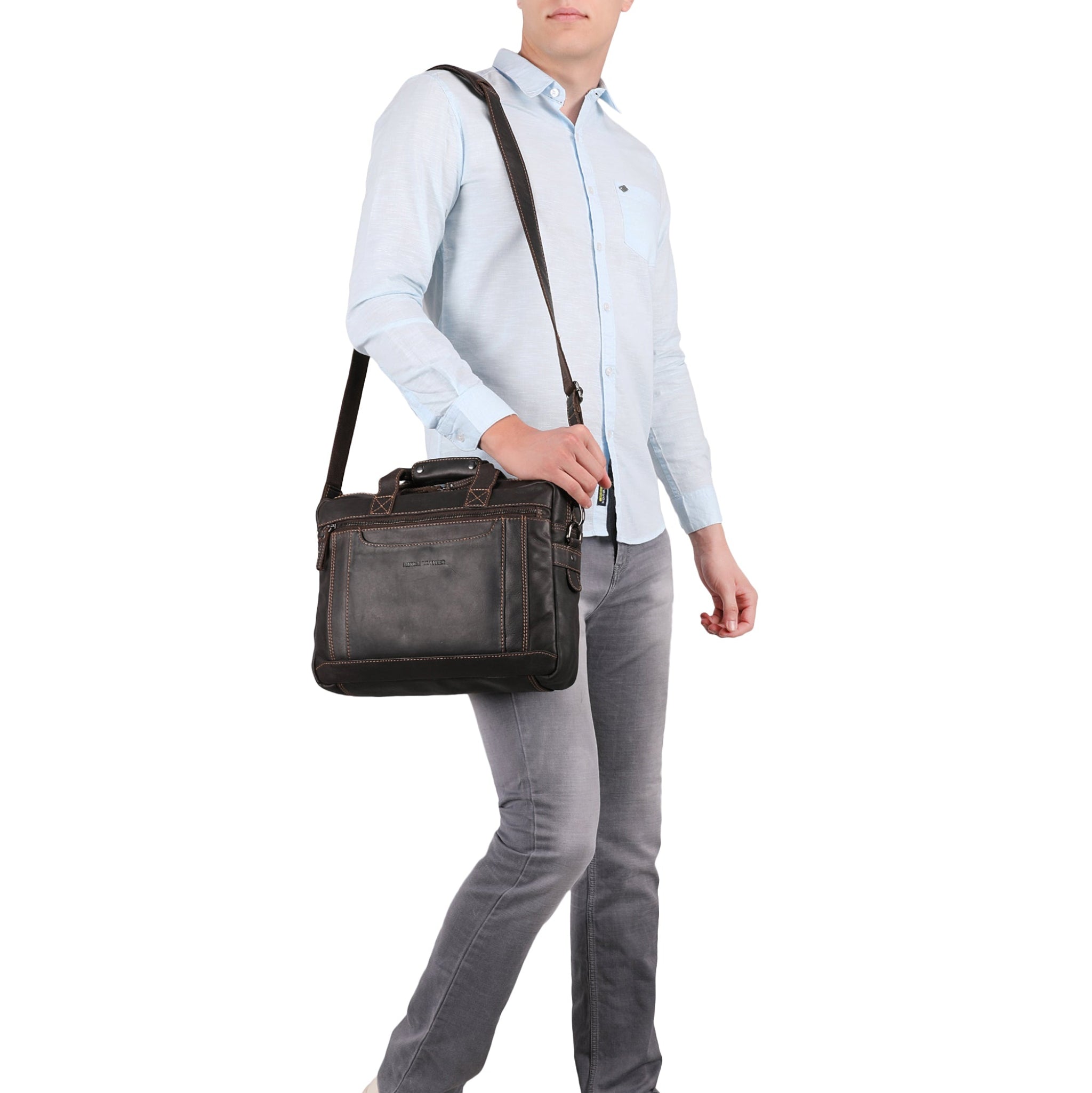 Man holding a Brown Minori leather briefcase against a white background